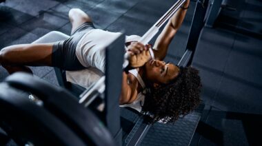 A person doing a barbell bench press.