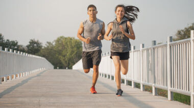 People running outdoors on bridge