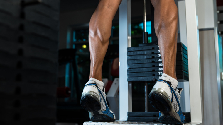 person performing calf raises on machine