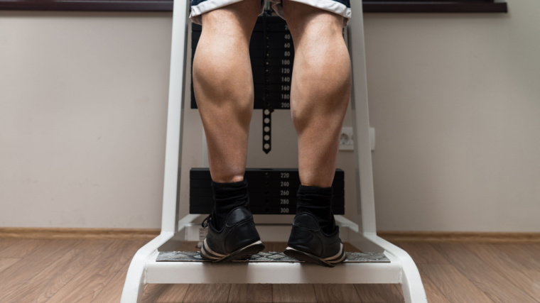 person doing calf raises in machine