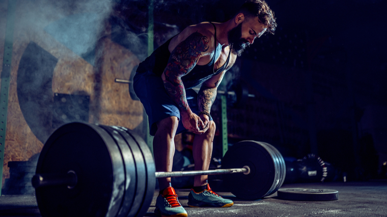 Man preparing to deadlift heavy barbell