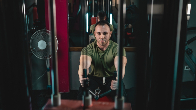 Man in gym performing back exercise