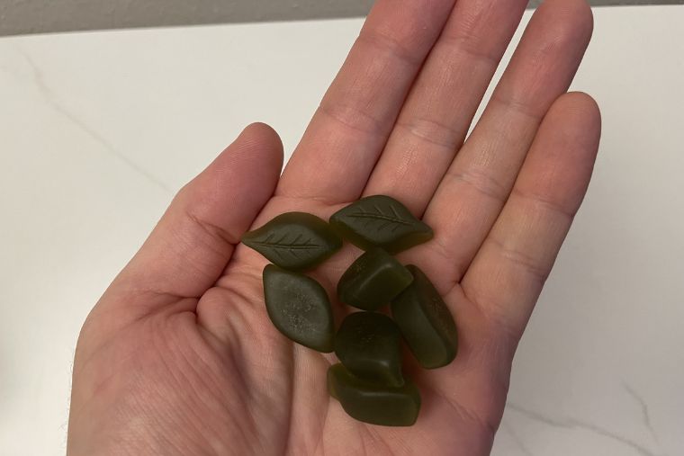 Several XWERKS Ashwa gummies in a man's hand